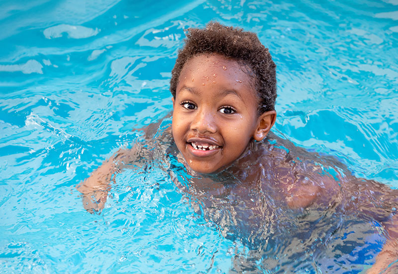 child-splashing-out-pool